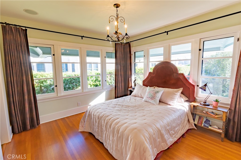 3216 2nd Street Long Beach, CA 90803 - Photo 32 of 62 a bedroom with a large bed and a chandelier