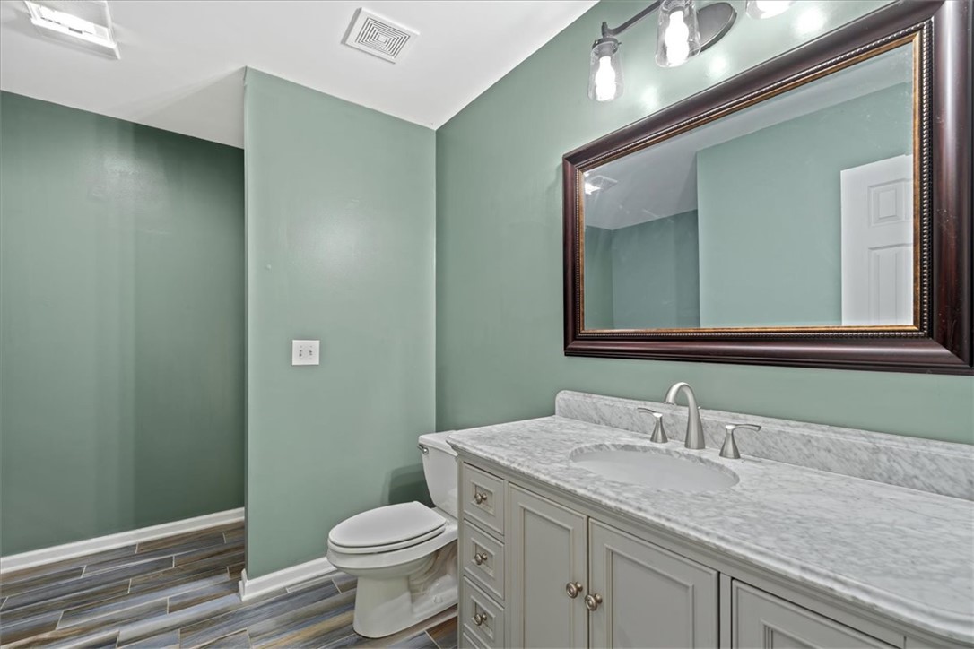 210 Briarcliff Road Central, SC 29630 - Photo 28 of 39 This clean bathroom showcases a modern vanity, sleek toilet, and elegant tiled flooring.