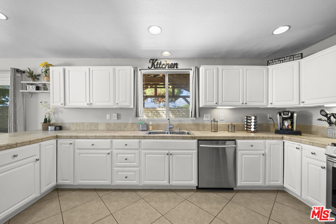 40335 Reata Road Palmdale, CA 93550 - Photo 11 of 37 a kitchen with sink cabinets and window