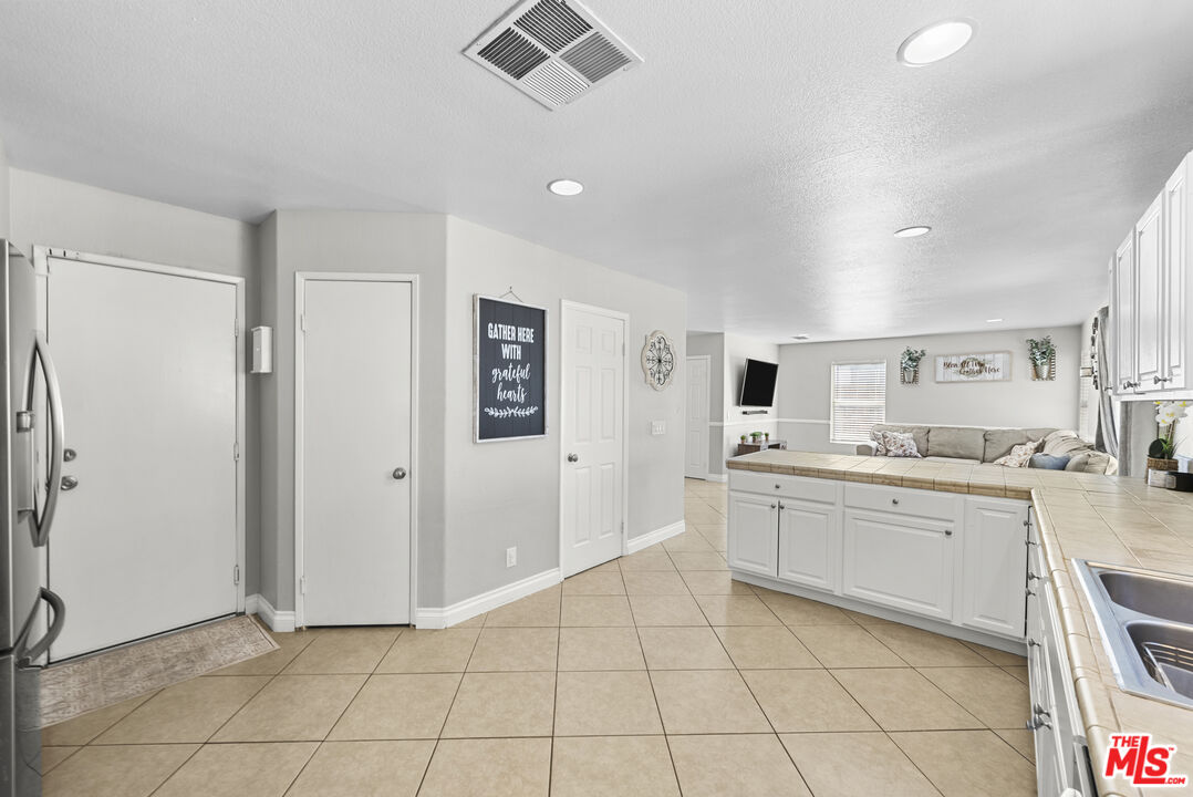 40335 Reata Road Palmdale, CA 93550 - Photo 13 of 37 a room with white cabinets and sink