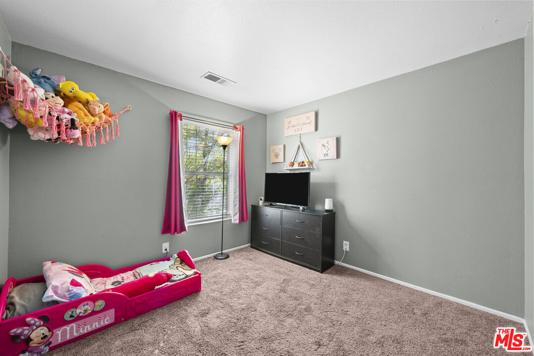 40335 Reata Road Palmdale, CA 93550 - Photo 16 of 37 a bedroom with a bed and a window