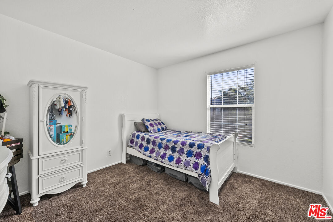 40335 Reata Road Palmdale, CA 93550 - Photo 18 of 37 a room with furniture and a window