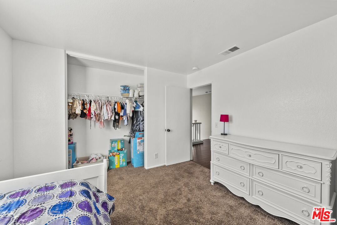 40335 Reata Road Palmdale, CA 93550 - Photo 19 of 37 a bed room with a bed and a window