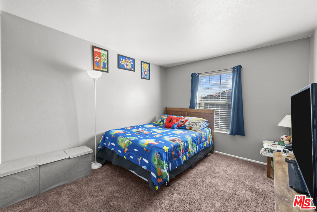 40335 Reata Road Palmdale, CA 93550 - Photo 20 of 37 a bedroom with a bed and a tv in it