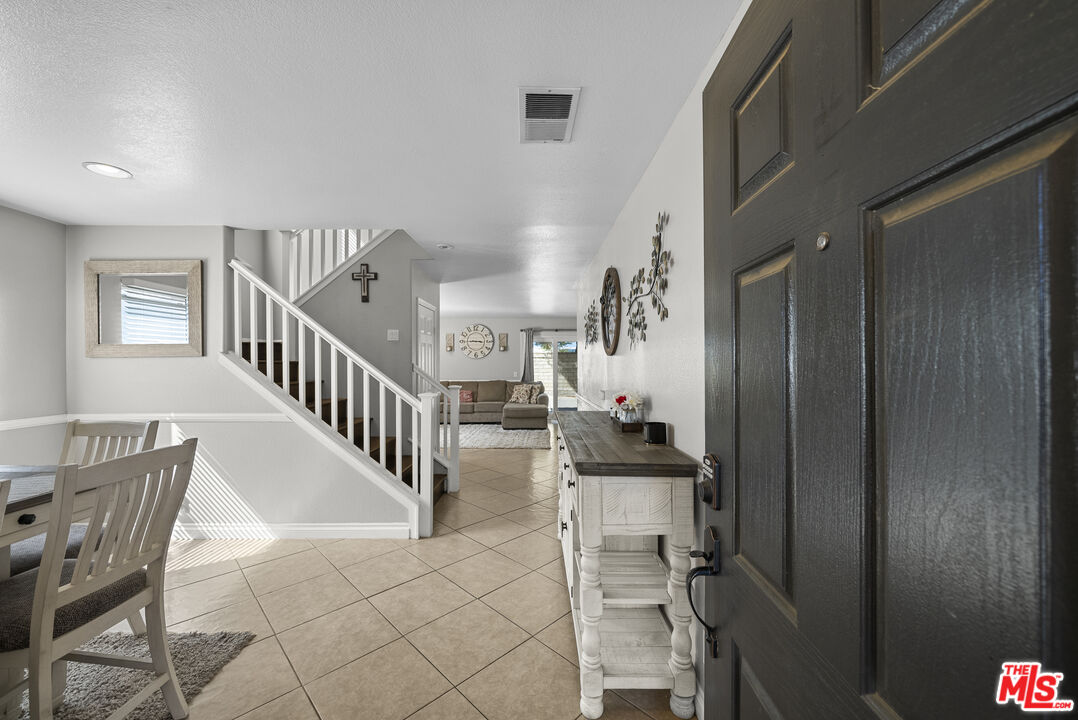 40335 Reata Road Palmdale, CA 93550 - Photo 2 of 37 a view of entryway and hall with dining room