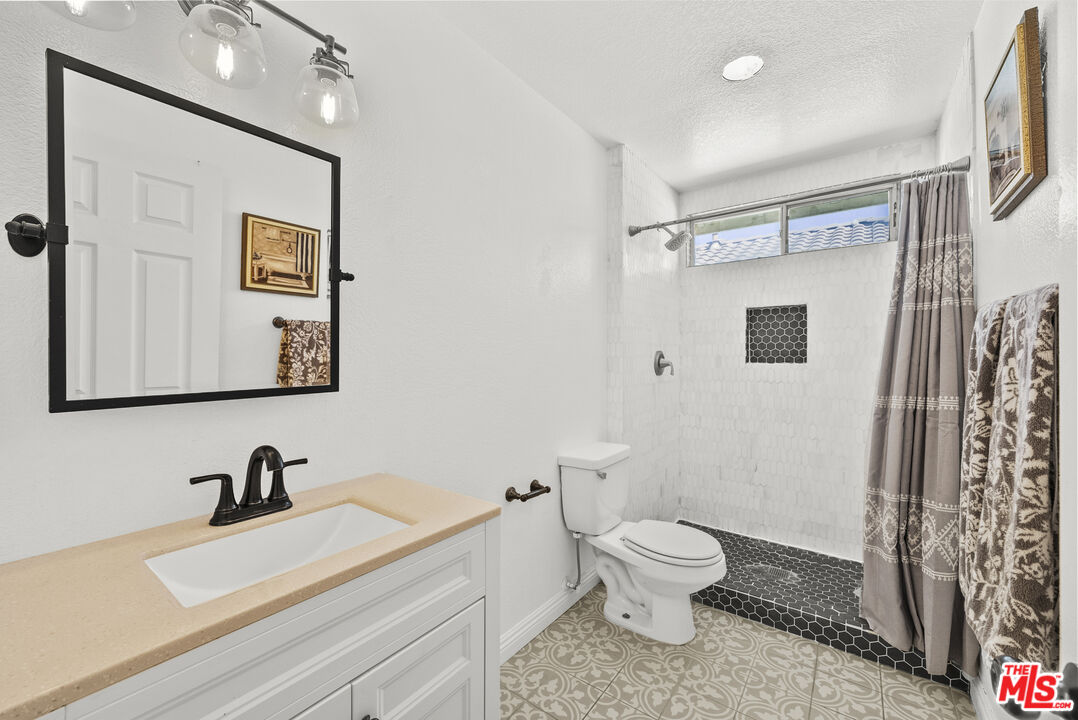 40335 Reata Road Palmdale, CA 93550 - Photo 22 of 37 a white toilet sitting next to a bathroom sink
