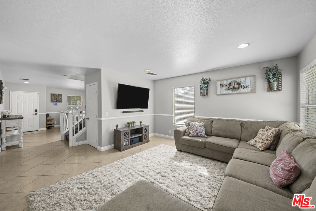 40335 Reata Road Palmdale, CA 93550 - Photo 6 of 37 a living room with furniture and a flat screen tv
