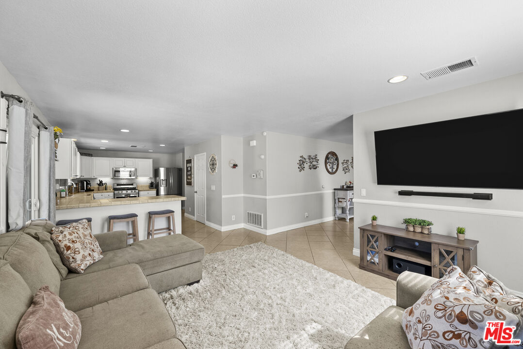 40335 Reata Road Palmdale, CA 93550 - Photo 7 of 37 a living room with furniture and a flat screen tv
