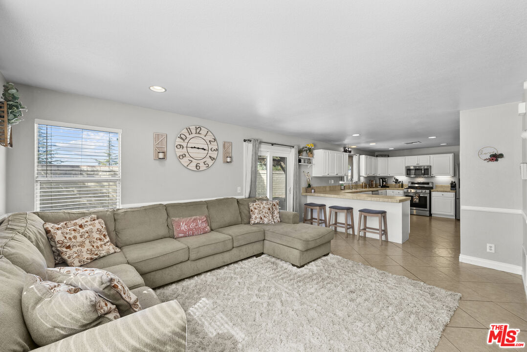 40335 Reata Road Palmdale, CA 93550 - Photo 8 of 37 a living room with furniture and view of kitchen