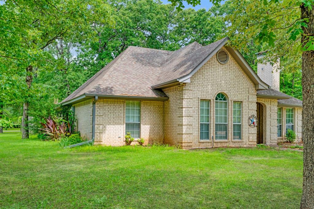 455 Timber Lakes Drive Powderly, TX 75473 - Photo 18 of 18 front view of a house with a yard