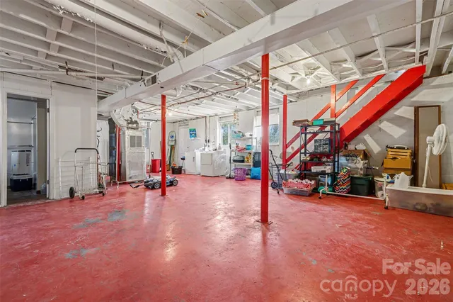 a view of a room with wooden floor and a sink