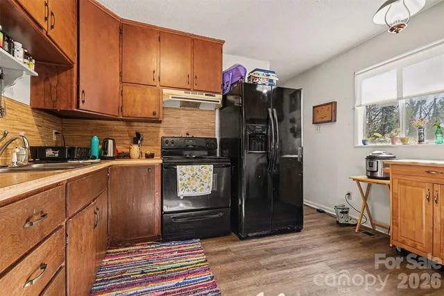 a kitchen with stainless steel appliances granite countertop a refrigerator and a sink