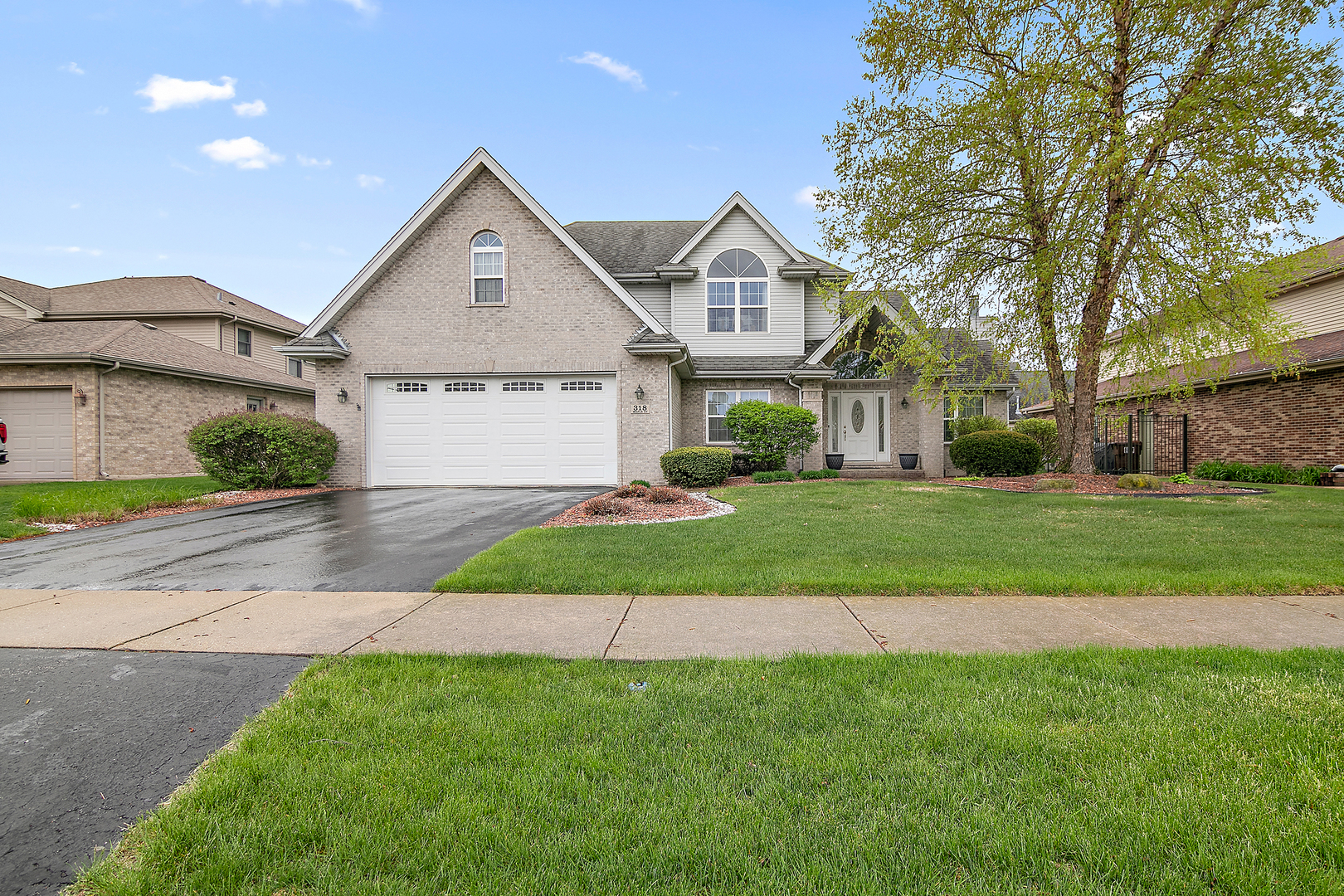 a front view of a house with a yard and garage