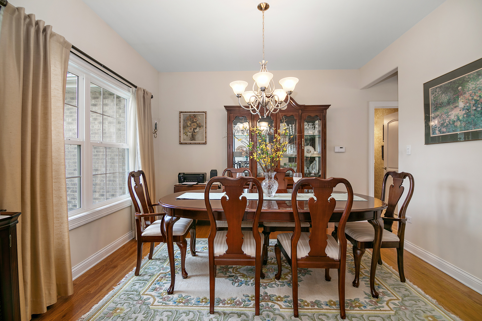 318 Maple Street Beecher, IL 60401 - Photo 12 of 27 a view of a dining room with furniture a chandelier and wooden floor