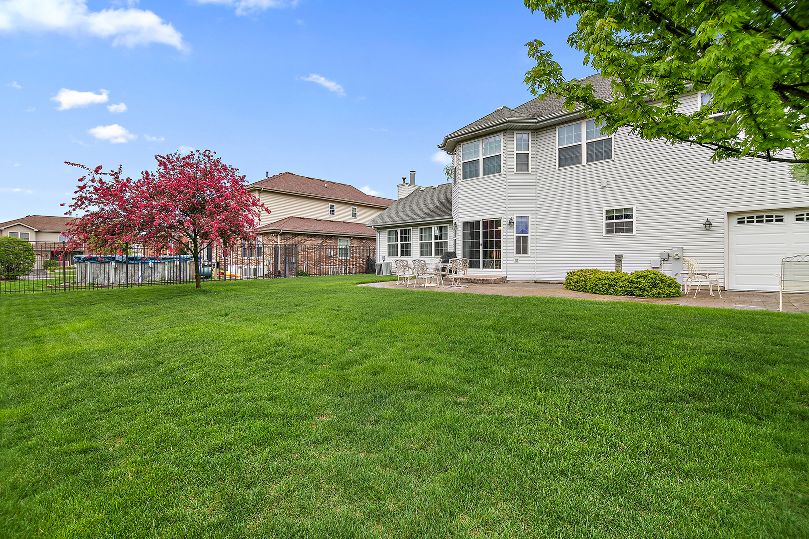 318 Maple Street Beecher, IL 60401 - Photo 25 of 27 a front view of a house with a garden and trees