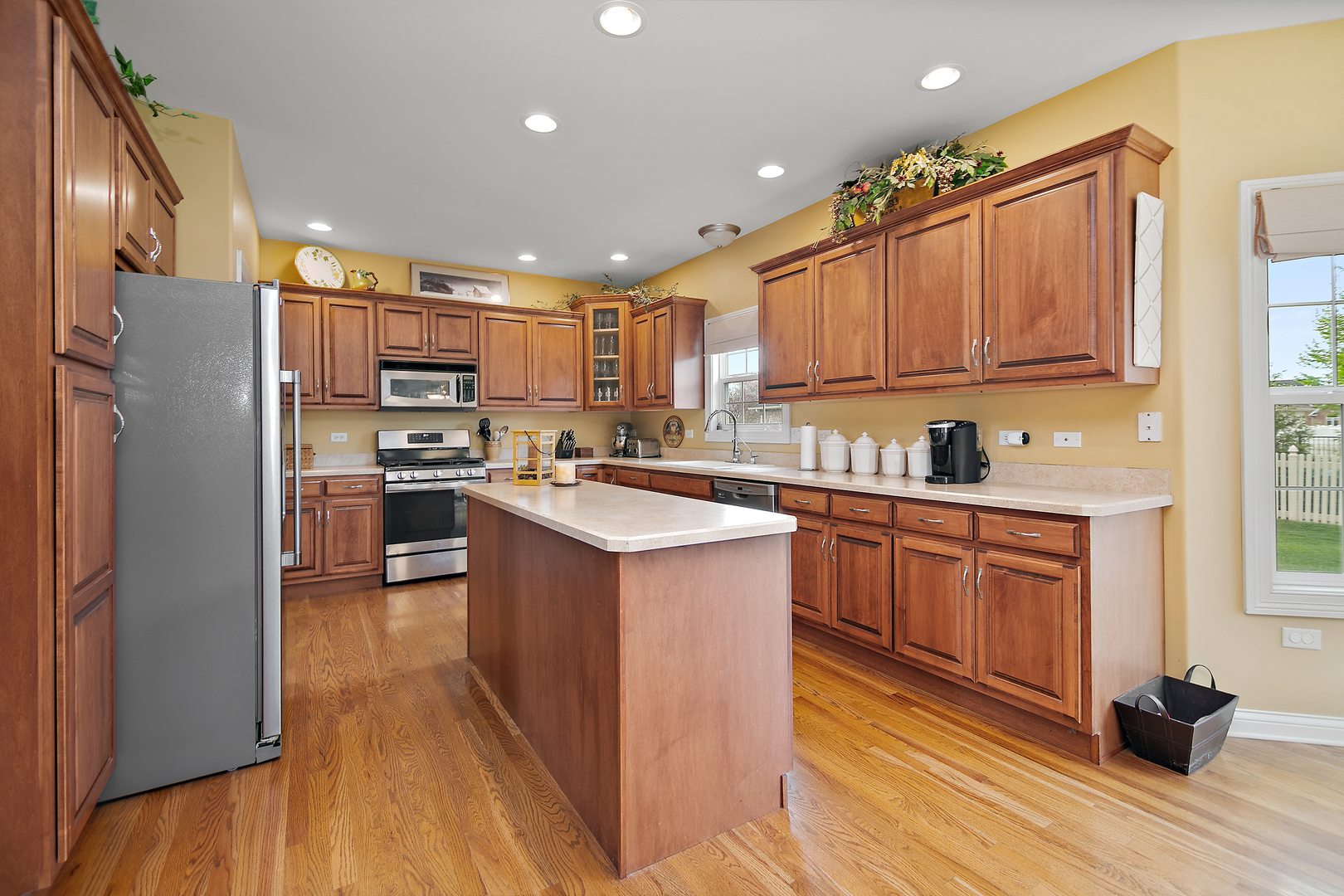318 Maple Street Beecher, IL 60401 - Photo 6 of 27 a kitchen with a refrigerator sink and wooden cabinets