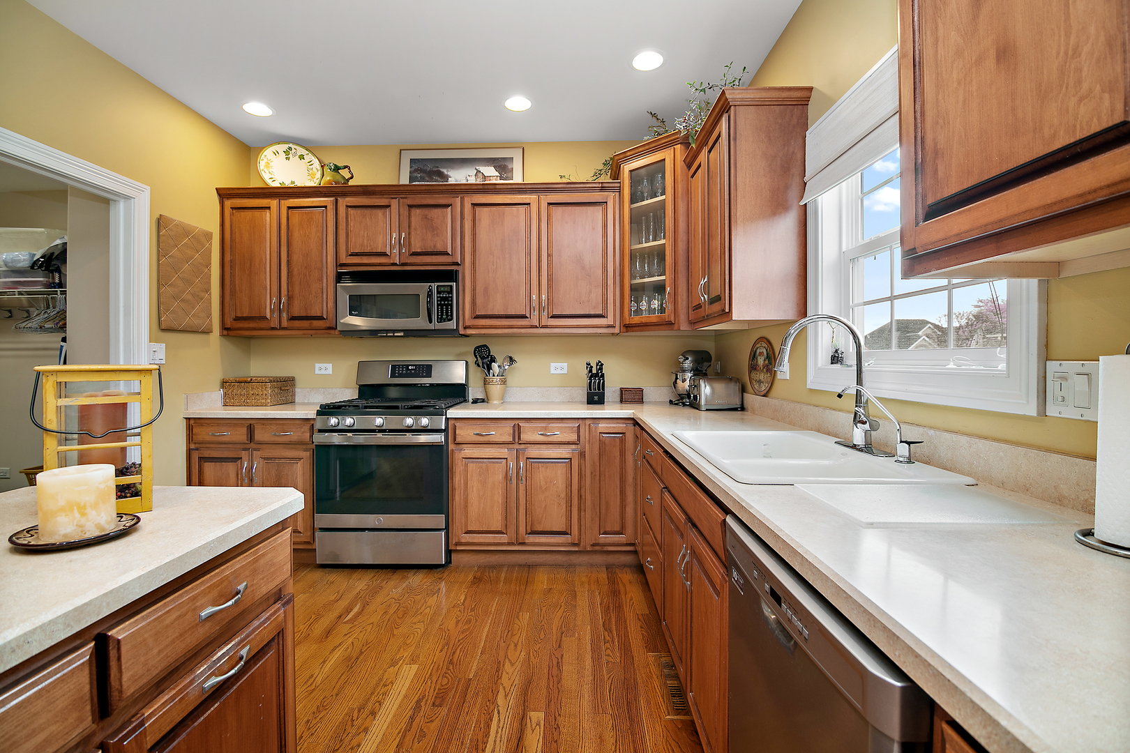 318 Maple Street Beecher, IL 60401 - Photo 7 of 27 a kitchen with granite countertop a sink cabinets and stainless steel appliances