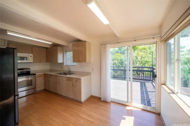 a kitchen with stainless steel appliances granite countertop a stove and a refrigerator
