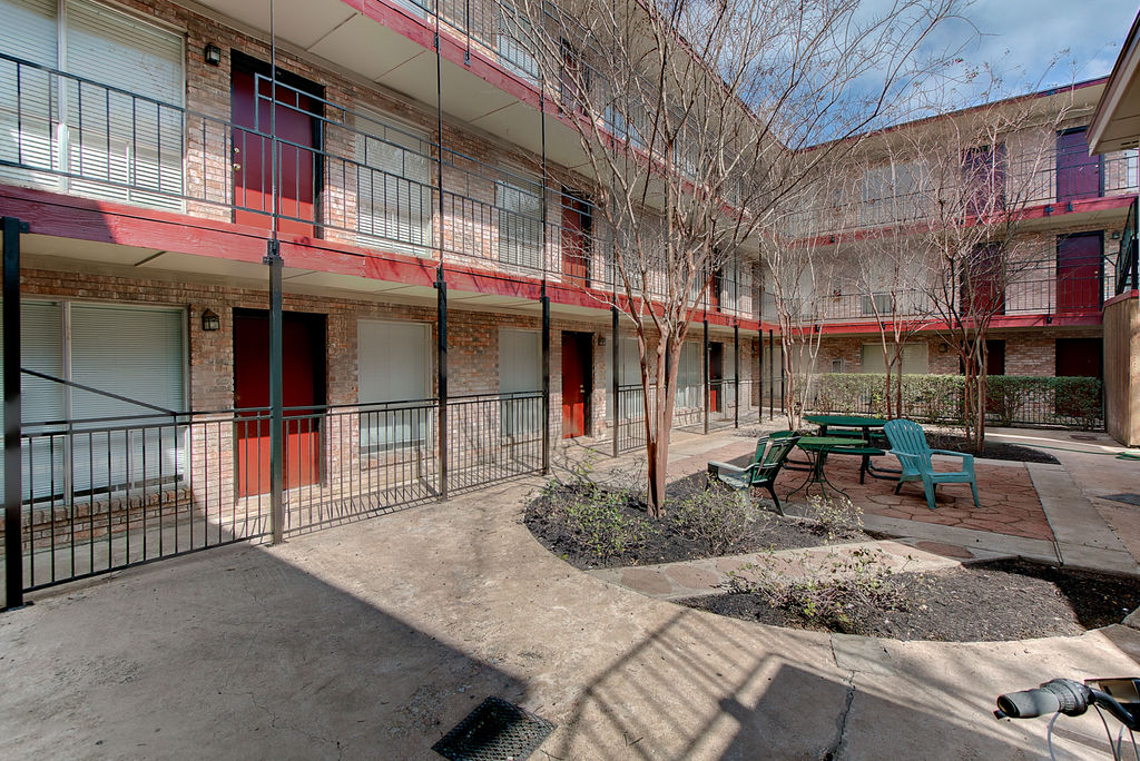 2207 Leon Street, Unit 207 Austin, TX 78705 - Photo 3 of 9 a view of a brick building with a large window