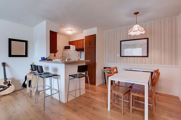 a dining room with furniture and wooden floor