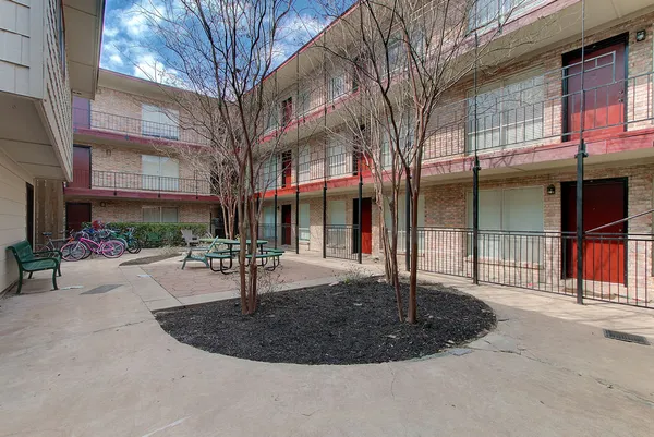 a view of a building with a backyard