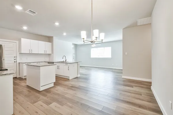 a large kitchen with kitchen island a sink stainless steel appliances and cabinets
