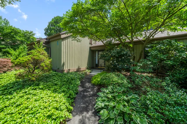 a view of a house with a tree