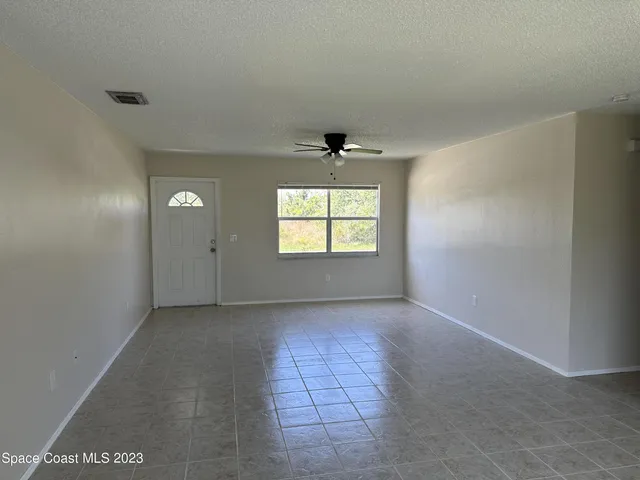 an empty room that has a window in it