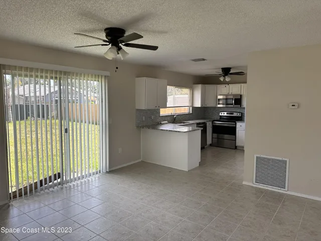 a view of a kitchen with microwave and stove top oven