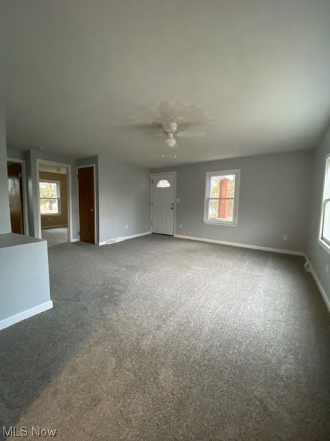 2216 Pressler Road Akron, OH 44312 - Photo 9 of 29 Carpeted spare room with plenty of natural light and ceiling fan