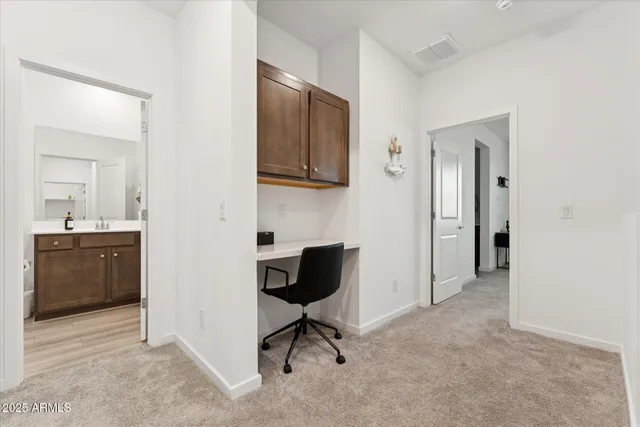 a view of a livingroom with a chair and cabinet
