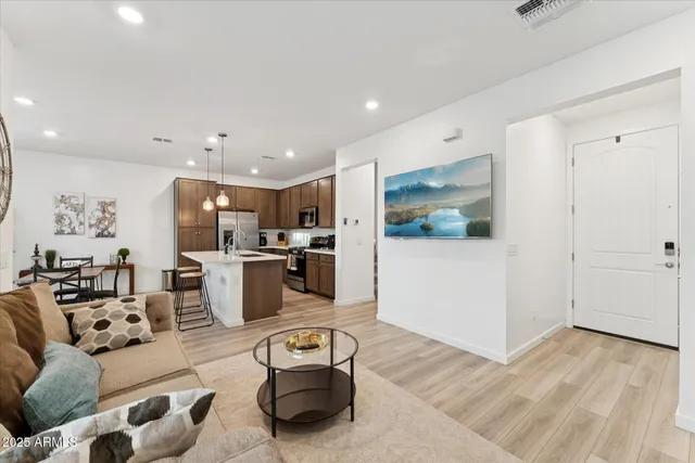 a living room with furniture and kitchen view