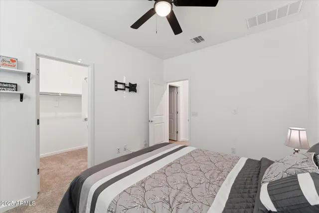 a bedroom with a bed and a painting on the wall