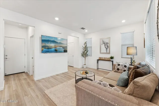 a living room with furniture and wooden floor