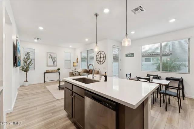 a kitchen with a table chairs stove and wooden floor