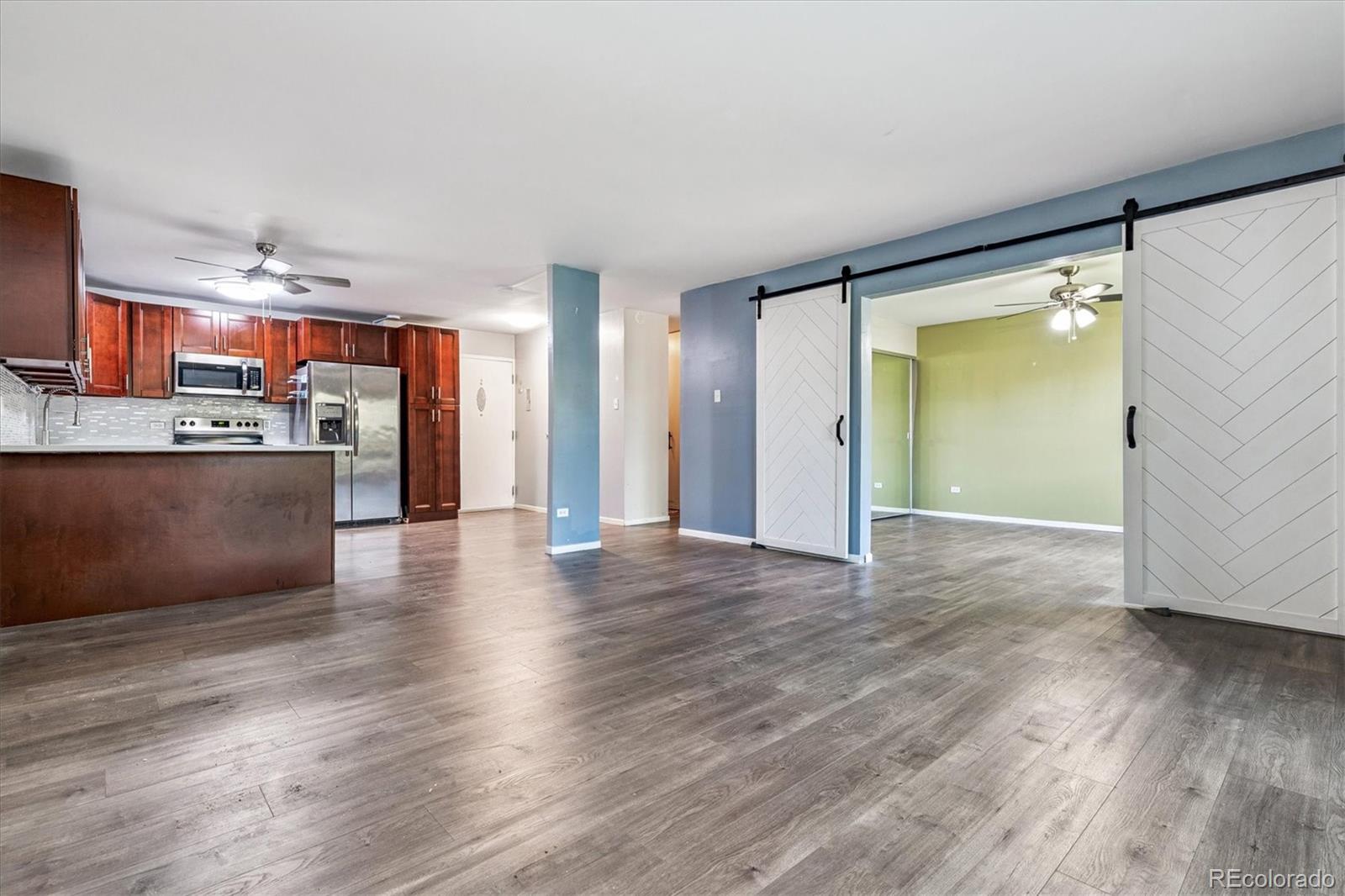 595 South Alton Way, Unit 7B Denver, CO 80247 - Photo 11 of 38 a view of a kitchen with wooden floor and a kitchen