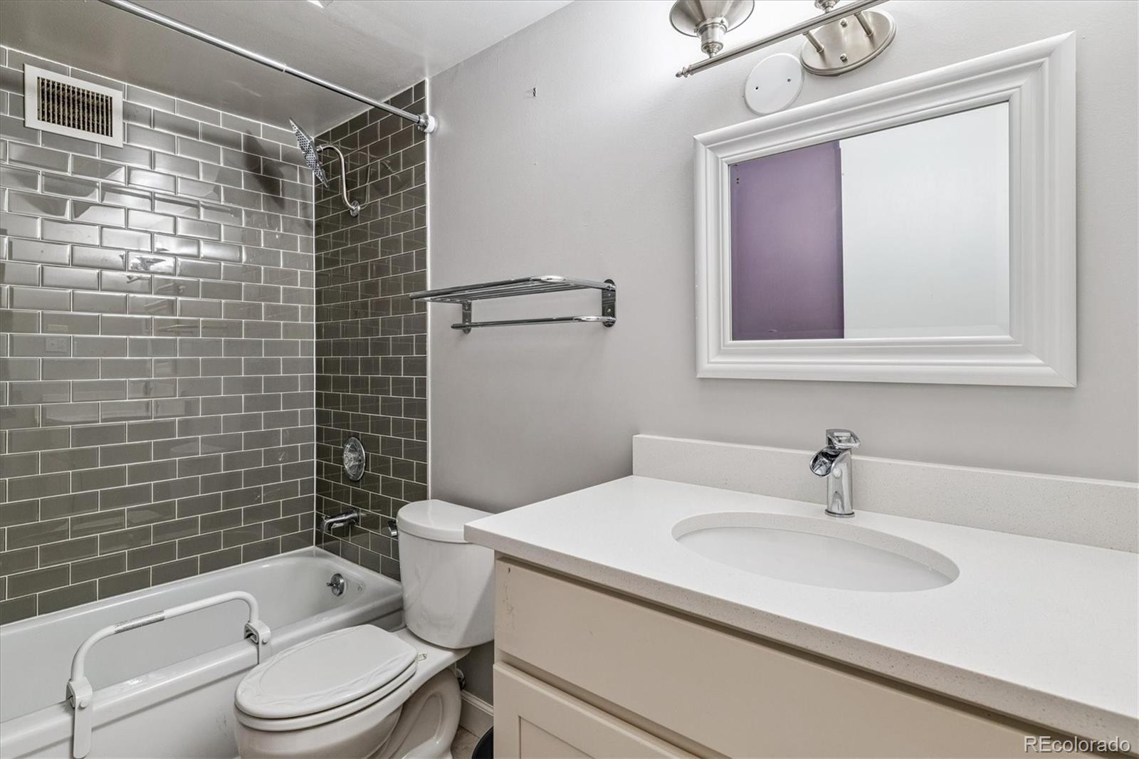 595 South Alton Way, Unit 7B Denver, CO 80247 - Photo 16 of 38 a bathroom with a sink toilet and shower
