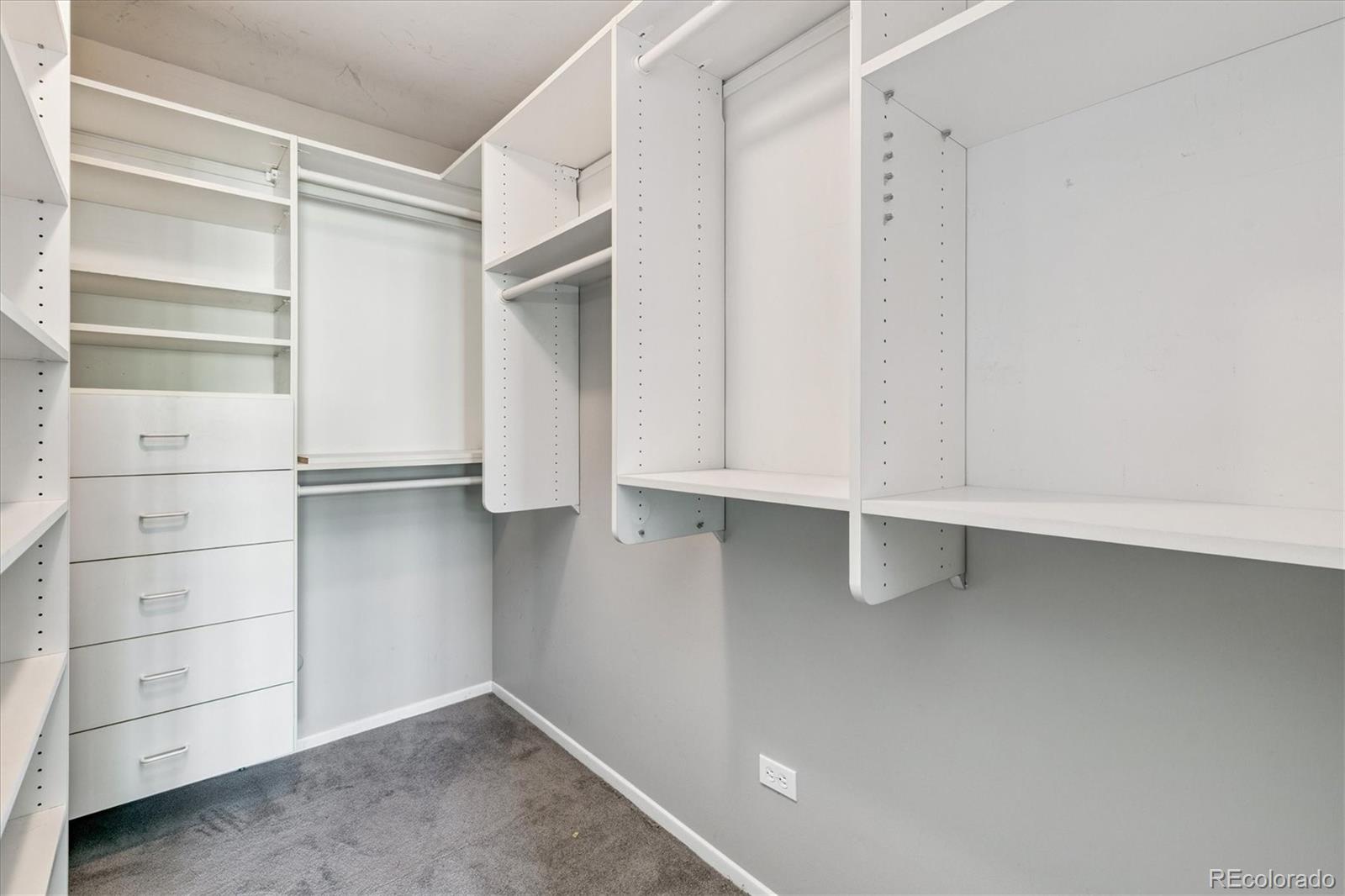 595 South Alton Way, Unit 7B Denver, CO 80247 - Photo 19 of 38 a view of walk in closet with empty racks