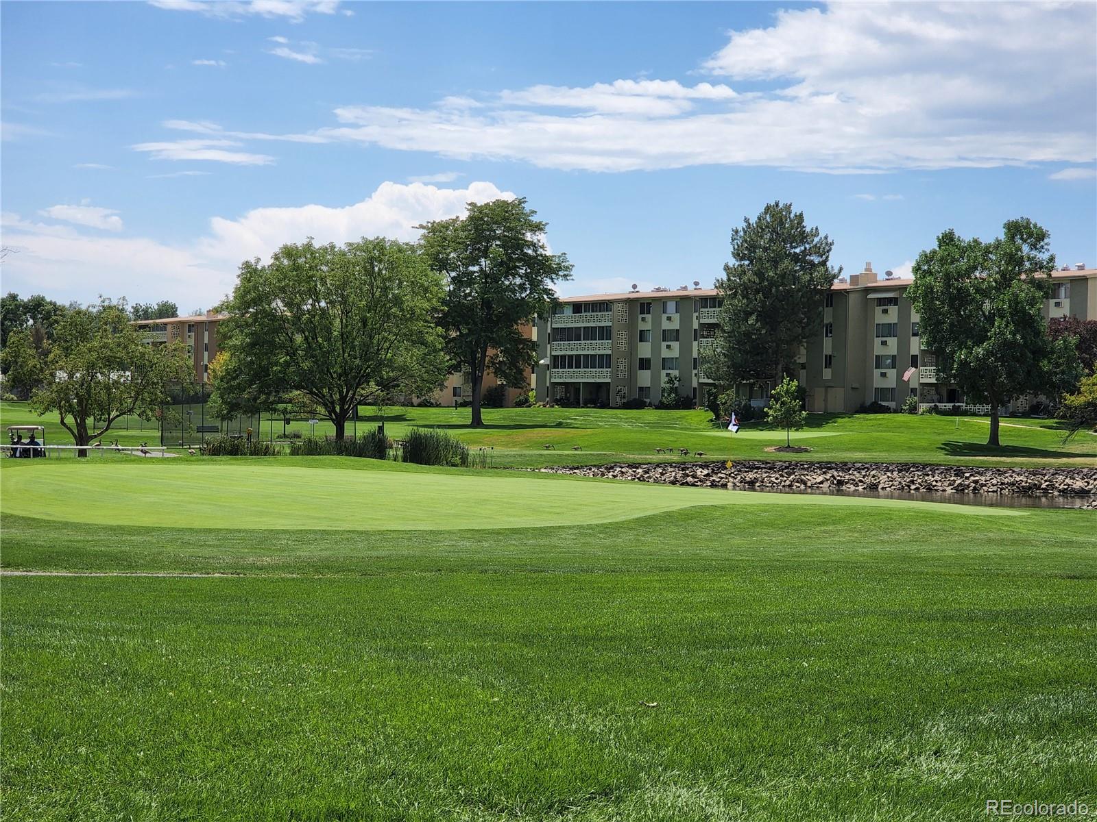 595 South Alton Way, Unit 7B Denver, CO 80247 - Photo 35 of 38 a view of a golf course with a garden
