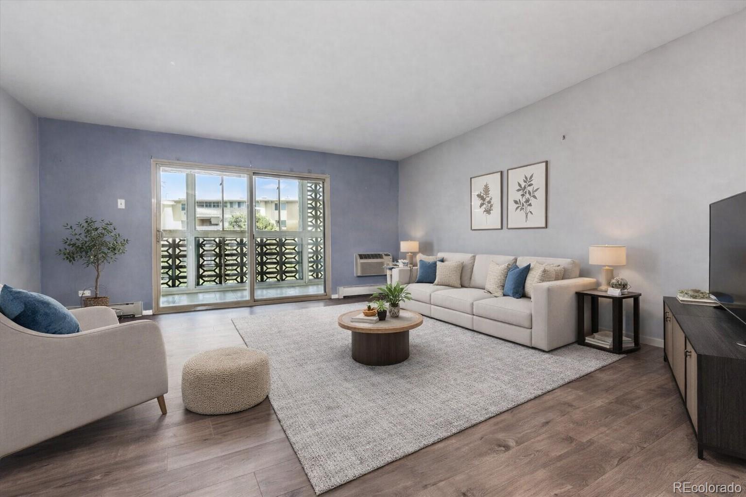 595 South Alton Way, Unit 7B Denver, CO 80247 - Photo 8 of 38 a living room with furniture and a large window
