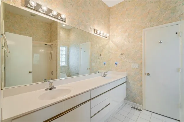 a bathroom with a double vanity sink mirror and double