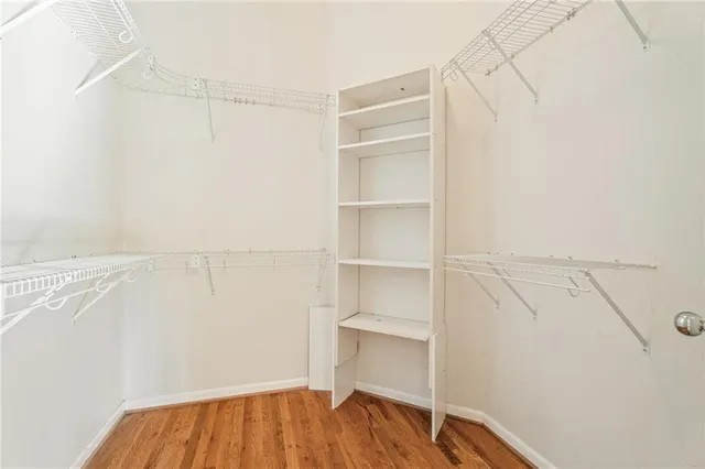 a view of walk in closet with empty racks
