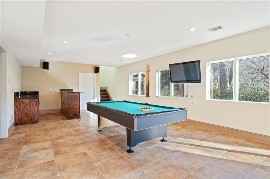 3010 Bluffton Way Roswell, GA 30075 - Photo 16 of 21 a living room with furniture a flat screen tv and a table