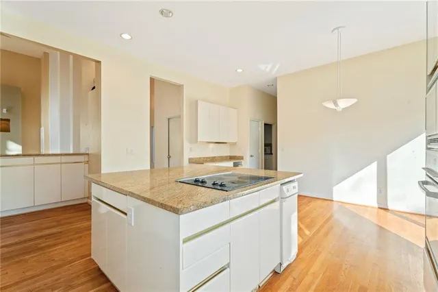 a kitchen that has a sink and a stove in it