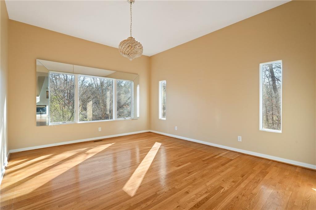 3010 Bluffton Way Roswell, GA 30075 - Photo 9 of 21 a view of an empty room with a window and wooden floor