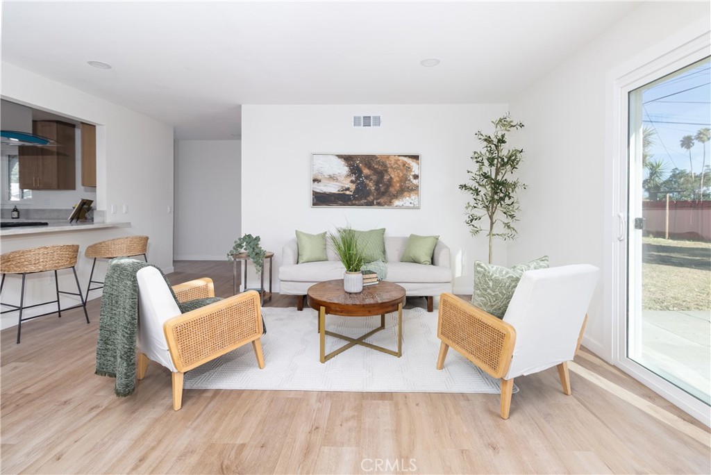 3306 Debbie Lane Riverside, CA 92501 - Photo 6 of 32 a living room with furniture and a wooden floor