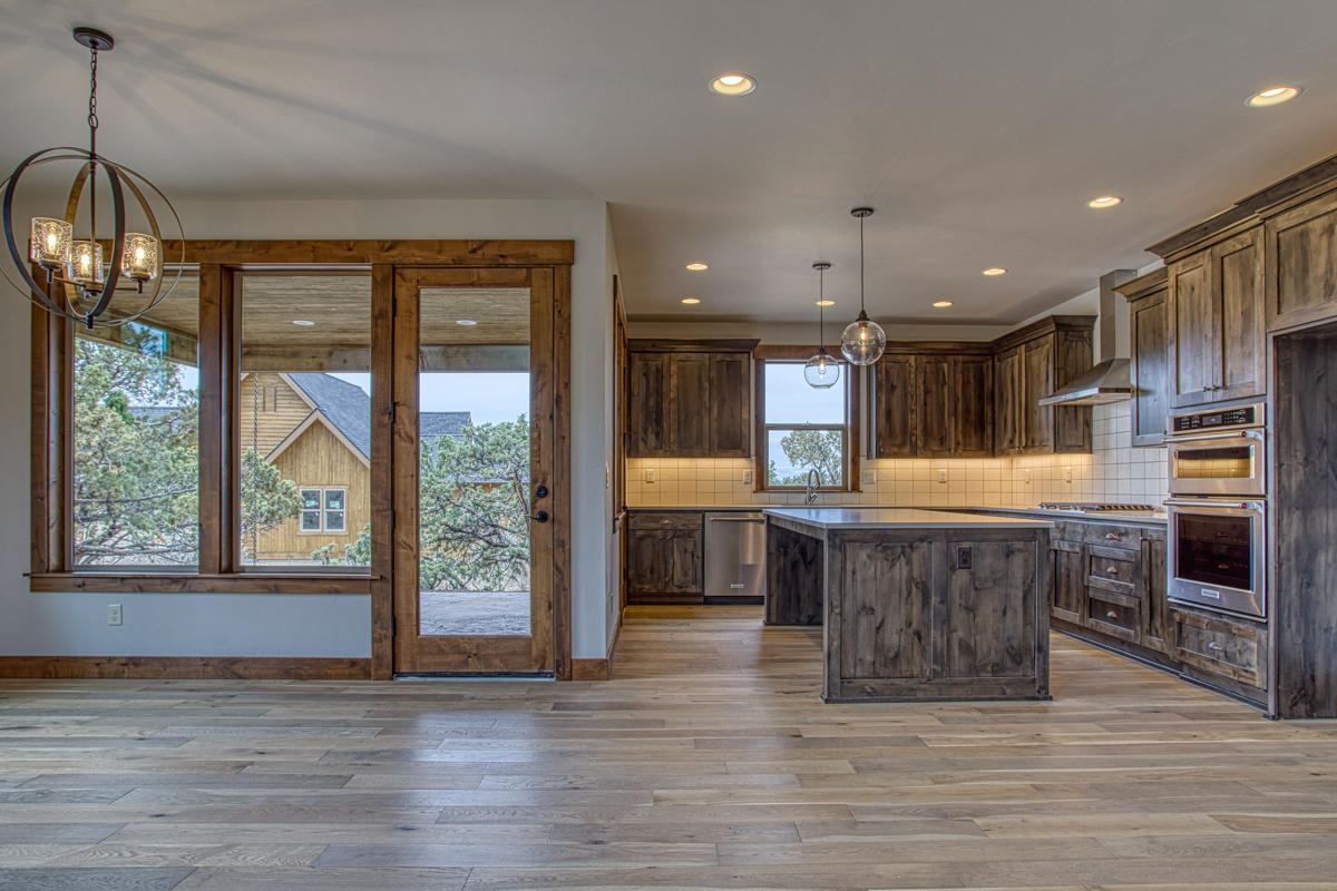 15751 South W Brasada Ranch Road, Unit LOT 363 Powell Butte, OR 97753 - Photo 46 of 47 a open kitchen with a large window and wooden floor