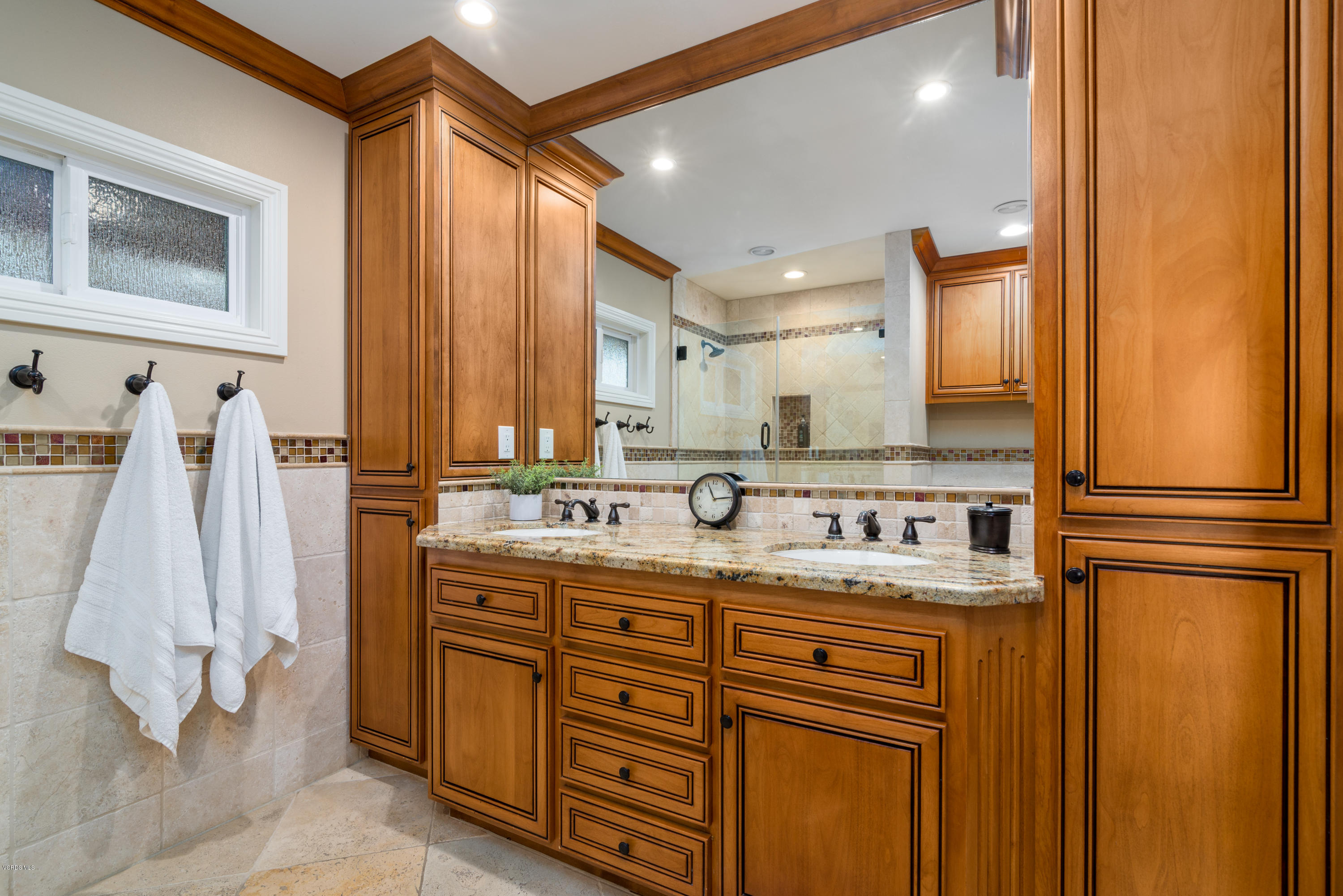 3327 Rancho Rio Bonita Road Covina, CA 91724 - Photo 30 of 58 a bathroom with a double vanity sink a mirror and a shower