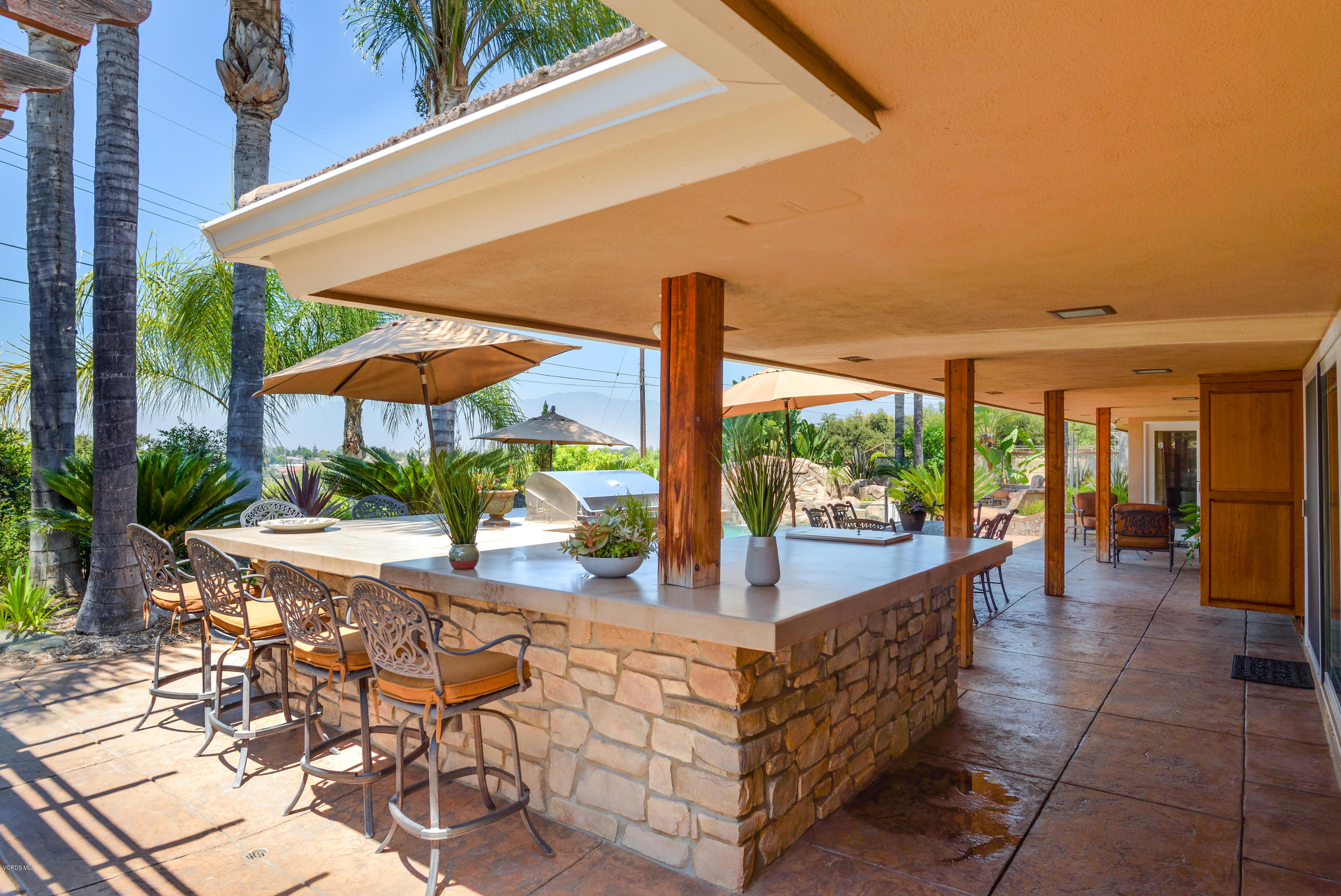 3327 Rancho Rio Bonita Road Covina, CA 91724 - Photo 43 of 58 a view of a patio with chairs and tables under an umbrella