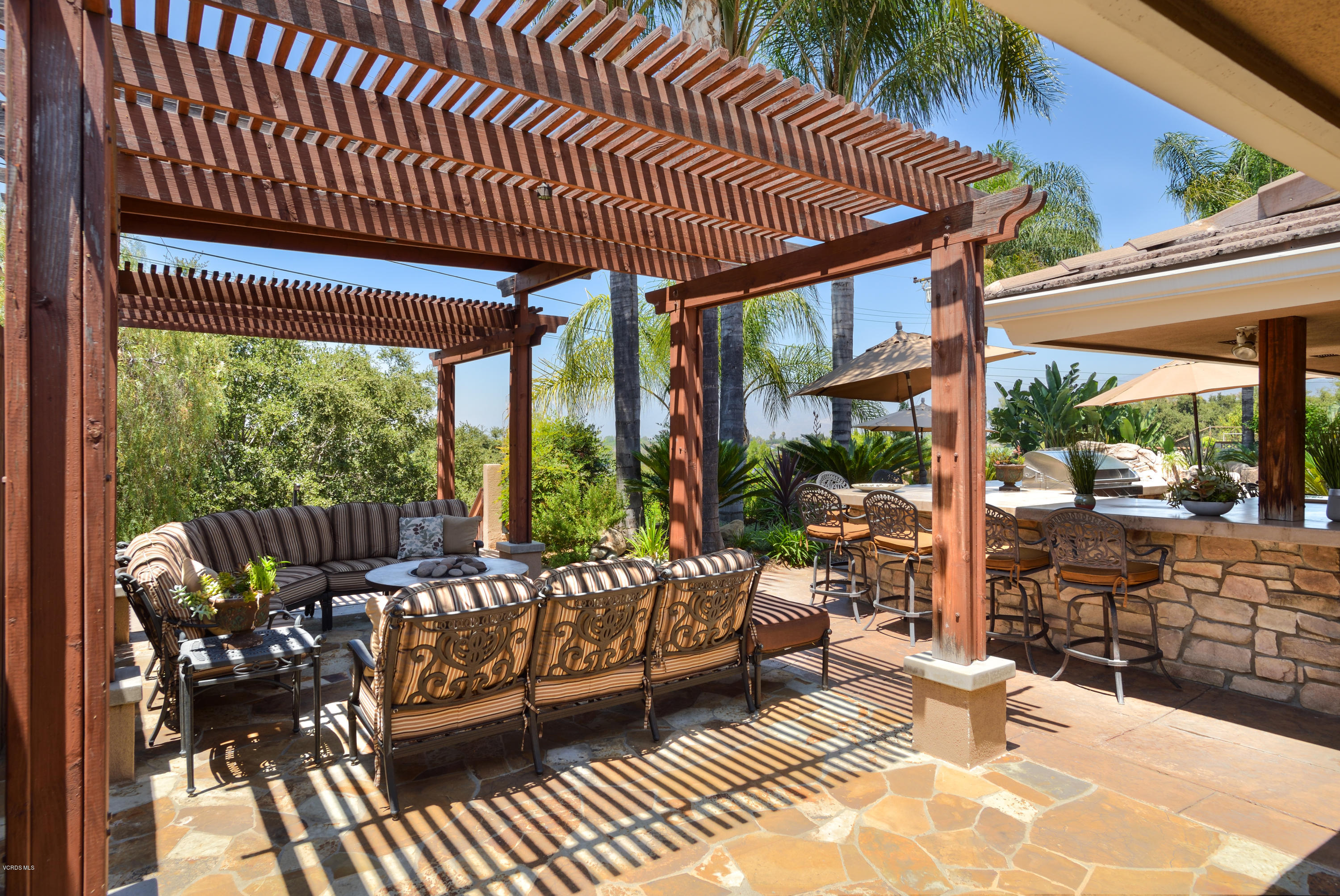 3327 Rancho Rio Bonita Road Covina, CA 91724 - Photo 45 of 58 a view of a patio with table and chairs potted plants and floor to ceiling window